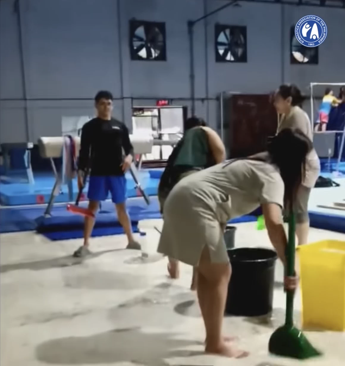 ATHLETES AND staff try to clear the water from the flooded gymnastics training center in Manila. (Gymnastics Association of the Philippines Facebook)
