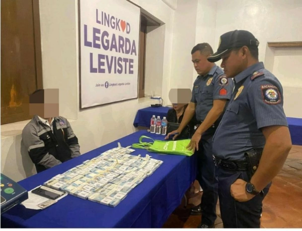 THE suspect (left) with the bribe money on the table.(Photo via Danny Estacio)