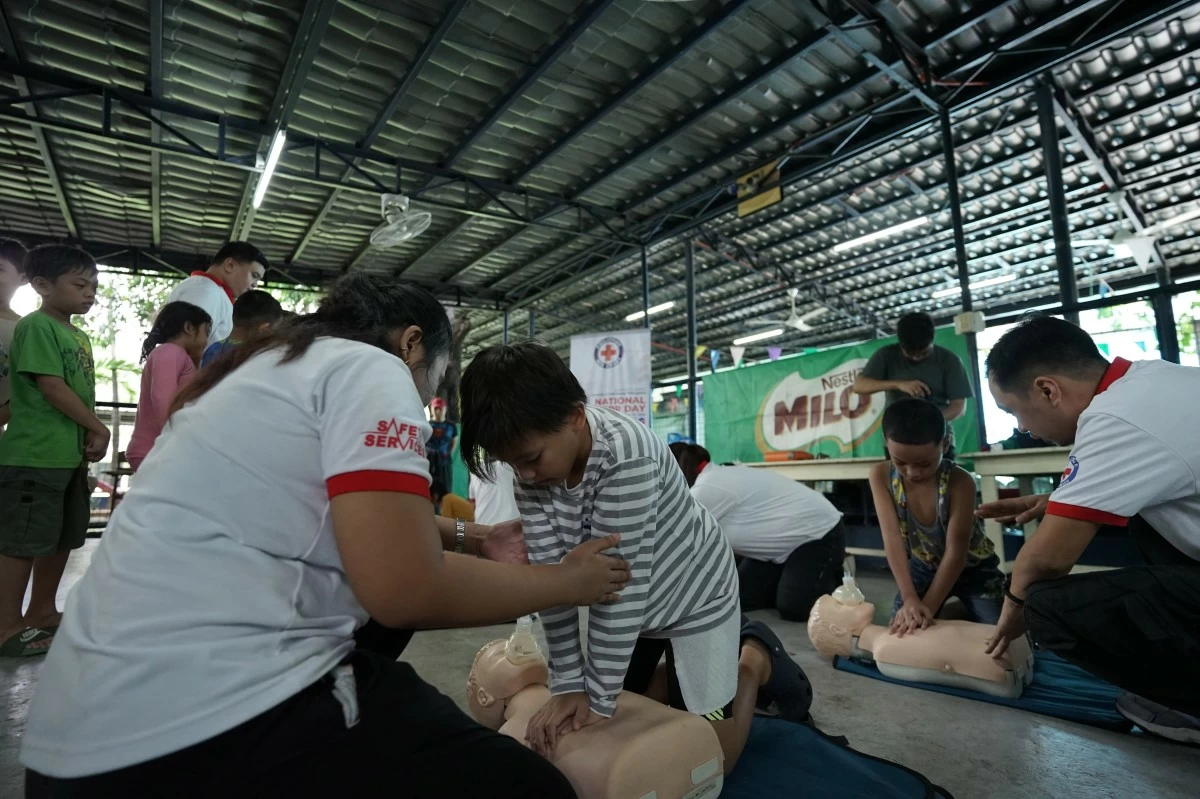 IN PHOTO: MILO® SAFE Swim participant practicing water safety techniques and Philippine Red Cross conducting CPR training for MILO® SAFE Swim participants
