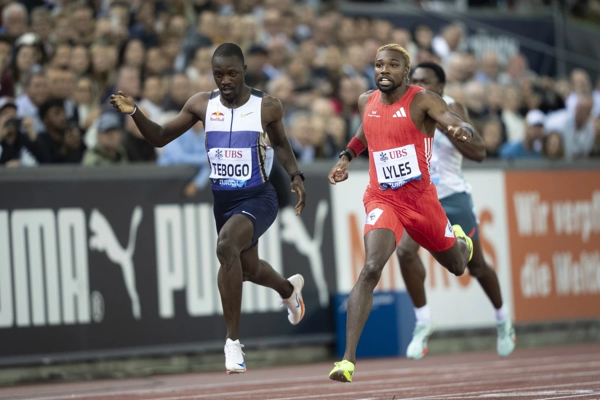 Noah Lyles of United States, right, crosses the finish line ahead of Botswana's Letsile Tebogo to win the men's 200-meter race at the World Athletics Diamond League final 2025 athletics meeting in Zurich, Switzerland, Thursday, Aug. 28, 2025. (Til Buergy/Keystone via AP)