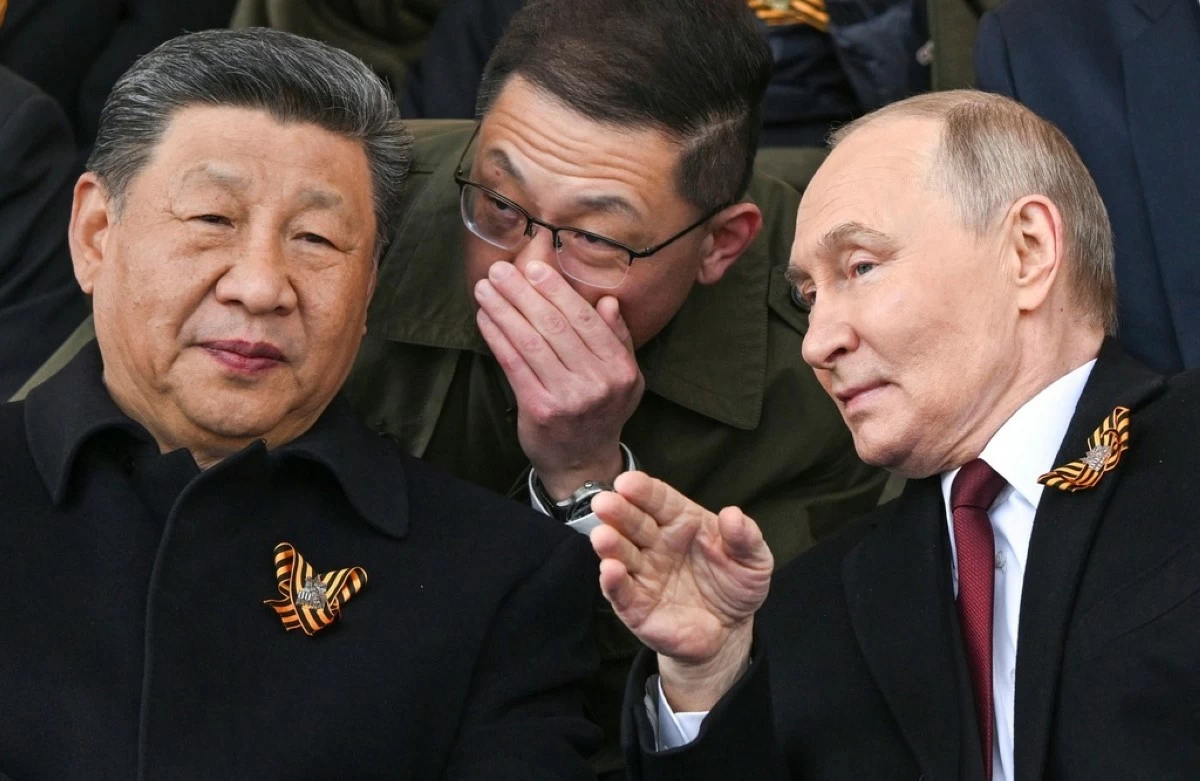 Russian President Vladimir Putin, right, and Chinese President Xi Jinping, left, talk as they watch the Victory Day military parade in Moscow, Russia, on May 9, 2025, during celebrations of the 80th anniversary of the Soviet Union's victory over Nazi Germany during the World War II. (Sergei Bobylev/Photo host agency RIA Novosti via AP, File)