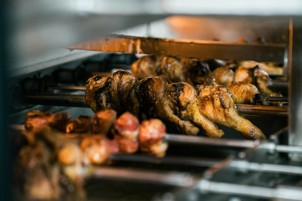 FLAME FEAST Skewers of premium cuts sear over an open fire, capturing the essence of Brazilian churrasco at Fogo de Chão.