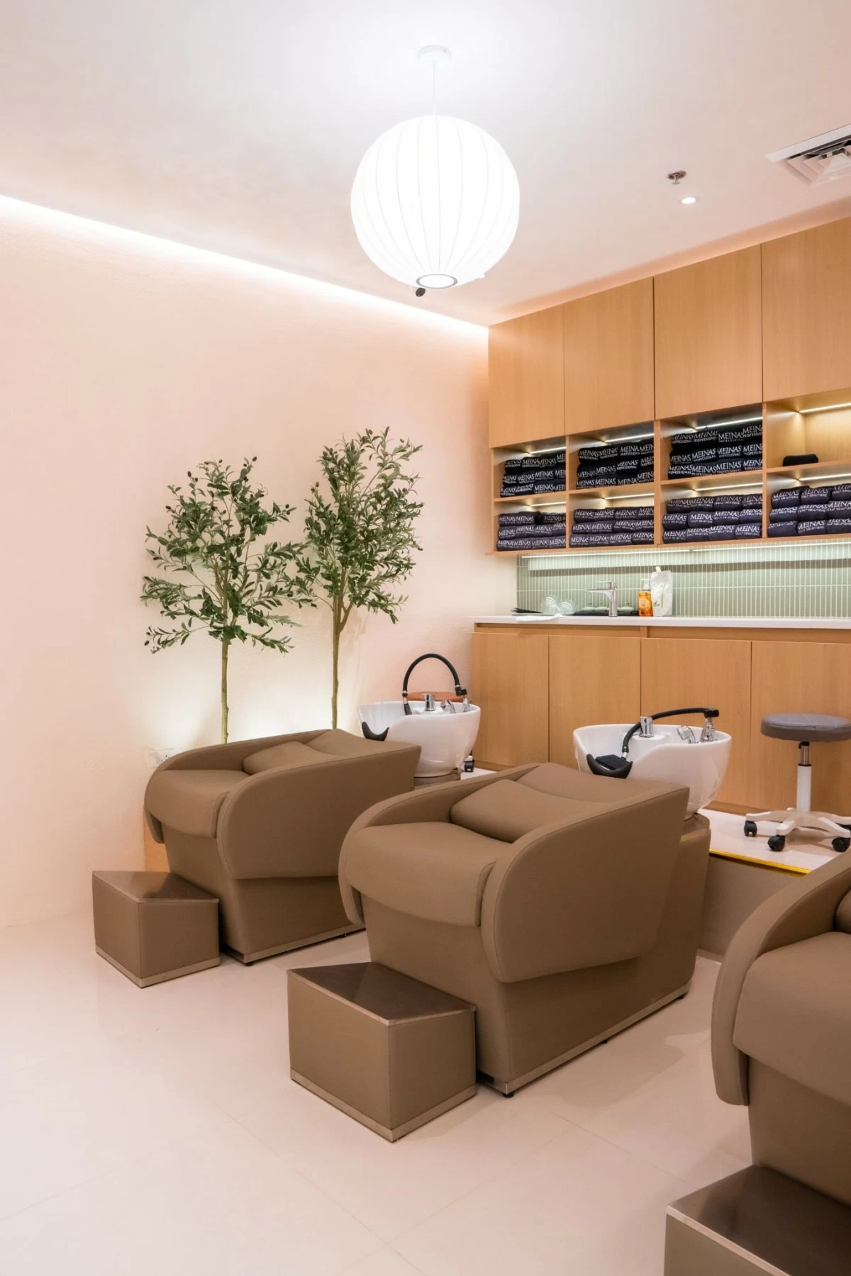 Soft curves and matte finishes create a warm, inviting space for your scalp and hair cleansing session.
