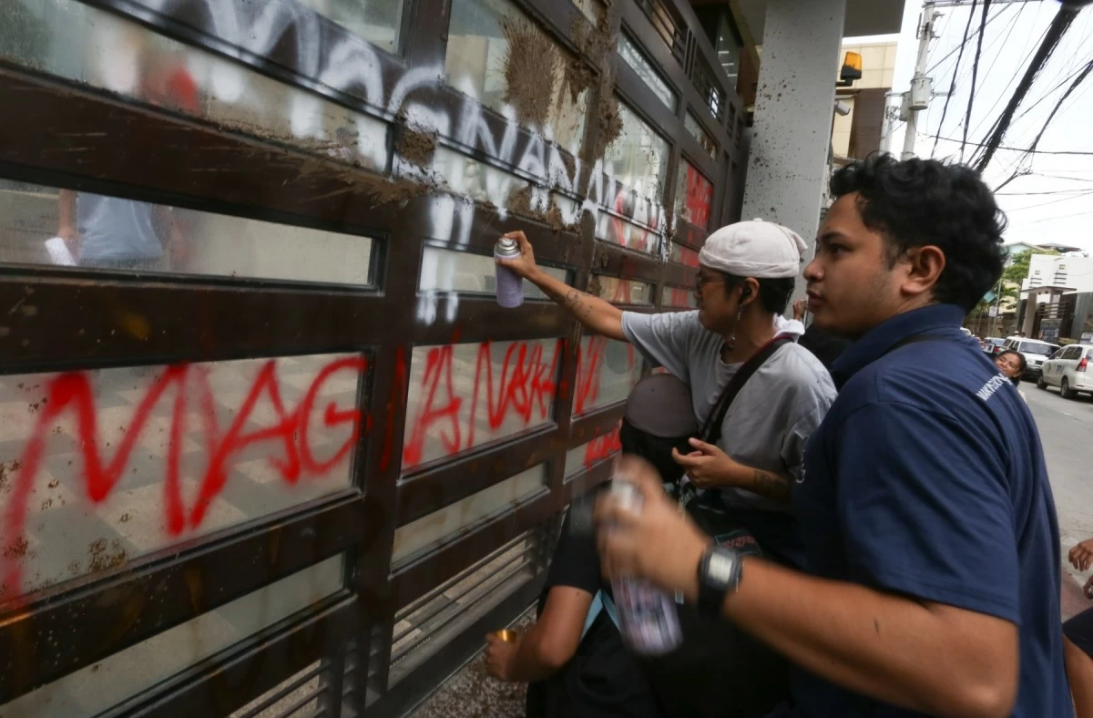 Members of the environmental group Kalikasan storm the St. Gerrard Construction office owned by the Discaya family in Pasig City on Thursday, September 4, 2025. The protesters hurled mud at the property, symbolizing the burden carried by flood victims due to failed flood-control projects. They also spray-painted the words “Magnanakaw” and “Korap” on the office walls and gate to express anger over alleged corruption in flood-control contracts awarded to the Discaya family’s companies. (Santi San Juan)