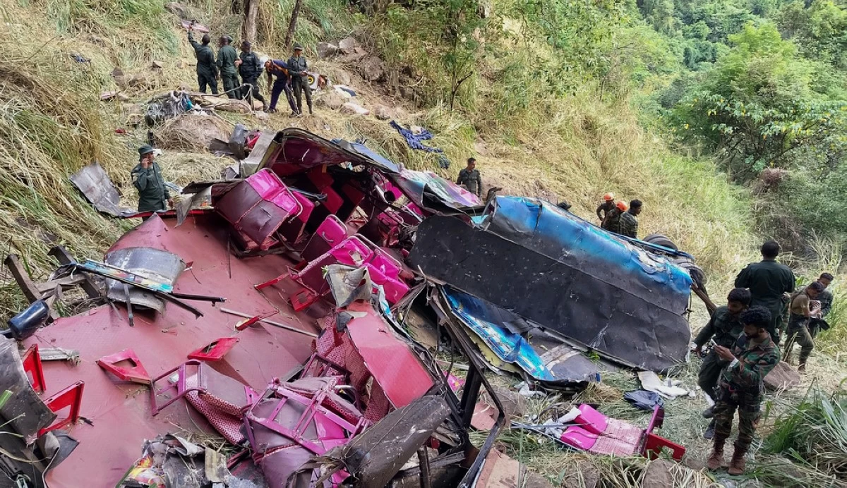 Soldiers and rescue workers stand by the debris of a passenger bus after it plunged into a precipice in Wellawaya, Sri Lanka, Friday, Sept. 5, 2025. (AP Photo/Prasanna Pathmasiri)