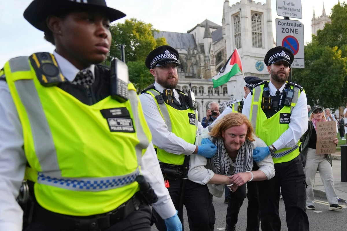 Police officers carry a protester during a protest to support Palestine Action in London, Saturday, Sept. 6, 2025.(AP Photo/Joanna Chan)