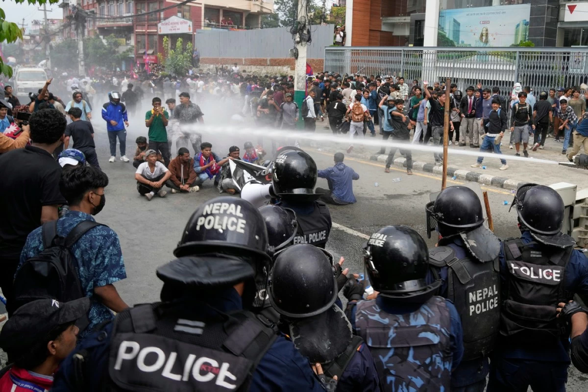 Riot police use a water cannon on protesters outside Parliament in Kathmandu, Nepal, Monday, Sept. 8, 2025. (AP Photo/Niranjan Shrestha)