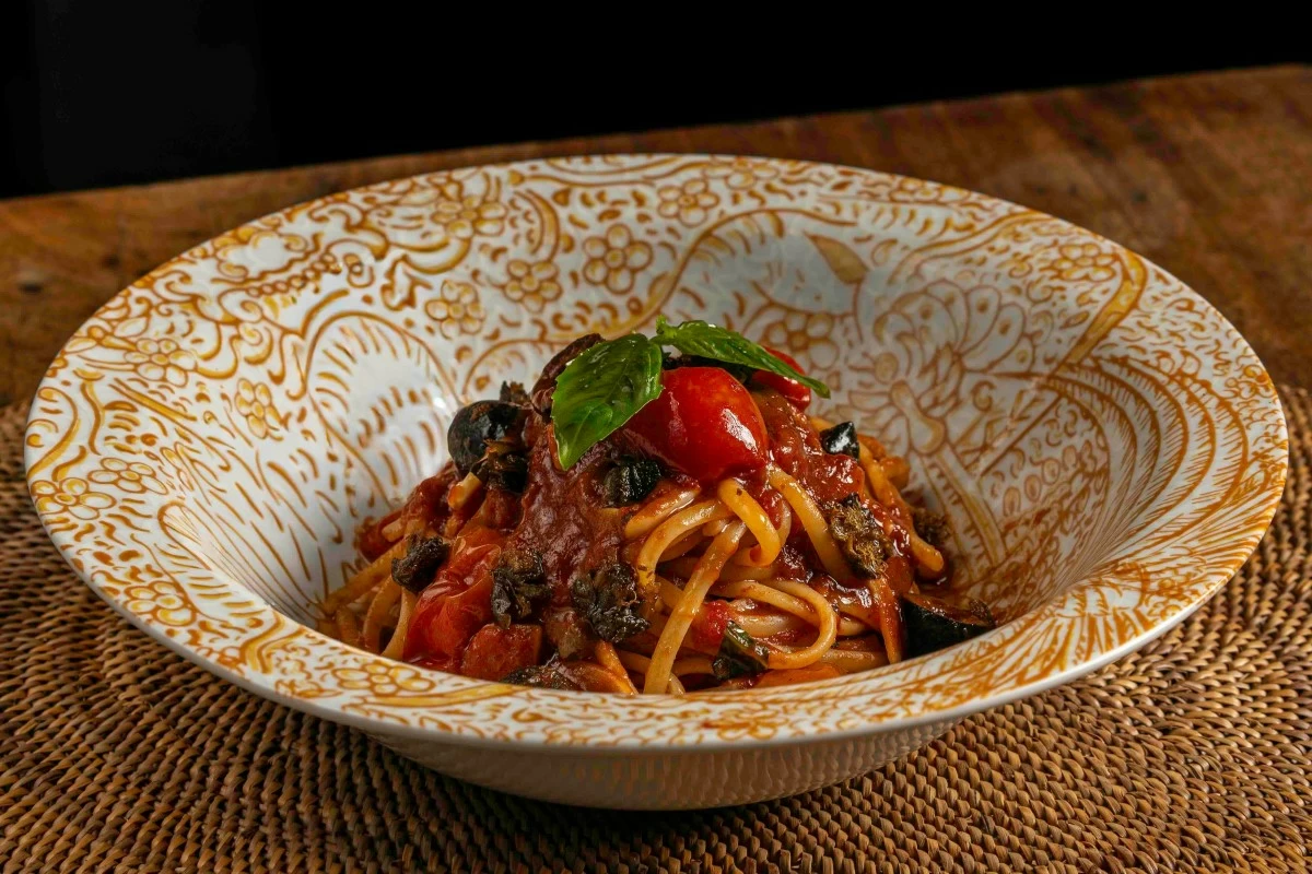 SAVORY SECRET Yuyuno Puttanesca layers linguine with black olives, capers, and the distinct depth of Ivatan fermented fish infused in olive oil.