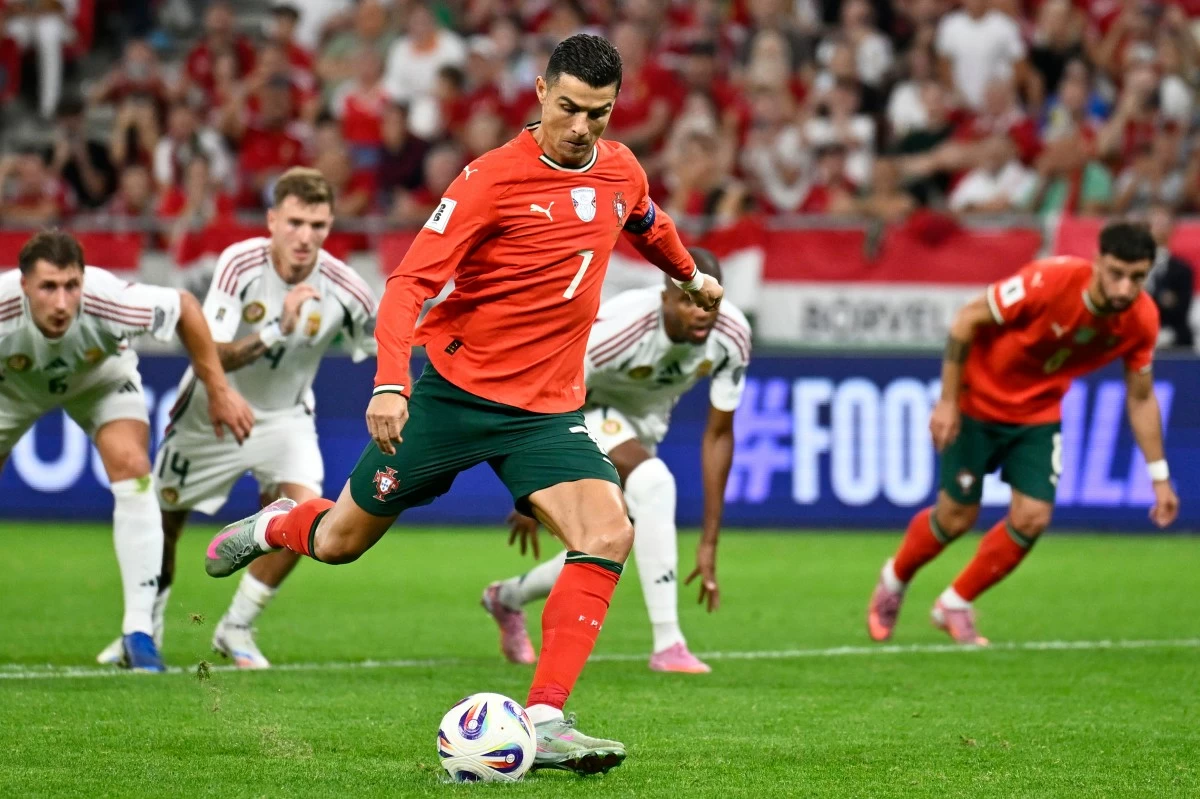 Portugal's Cristiano Ronaldo scores his side's second goal from the penalty spot during a World Cup 2026 group F qualifying soccer match between Hungary and Portugal at the Puskas Arena in Budapest, Tuesday, Sept. 9, 2025. (AP Photo/Denes Erdos)