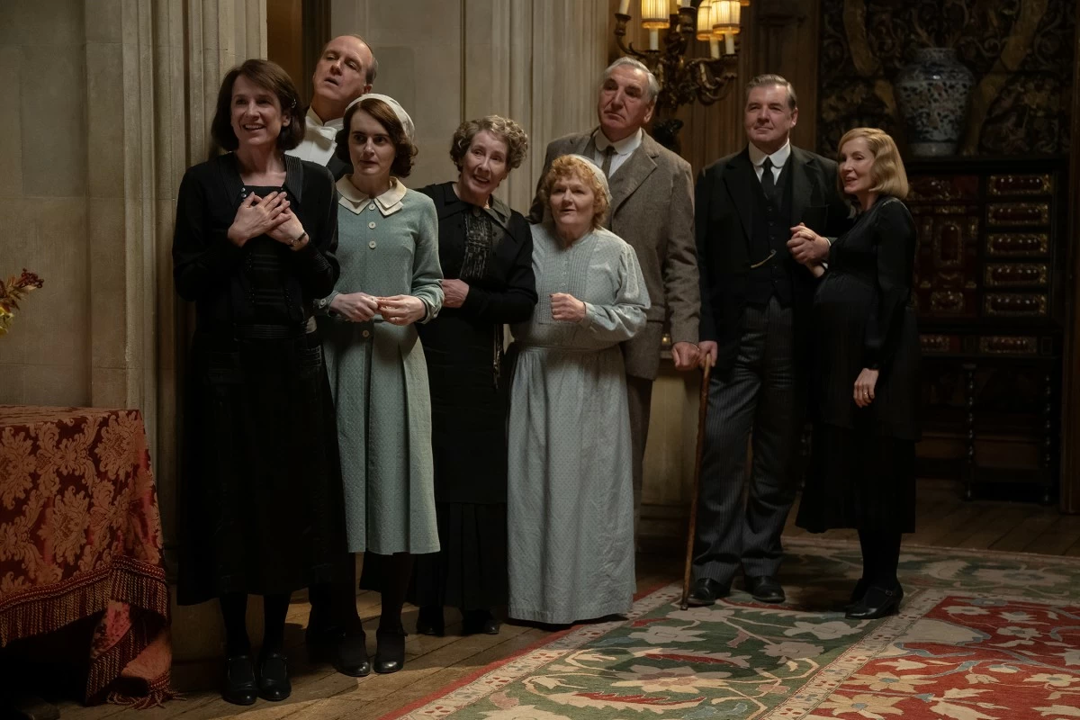 From left: Raquel Cassidy stars as Miss Baxter, Kevin Doyle as Mr. Molesley, Sophie McShera as Daisy Parker, Phyllis Logan as Mrs. Hughes, Lesley Nicol as Mrs. Patmore, Jim Carter as Mr. Carson, Brendan Coyle as Mr. Bates, and Joanne Froggatt as Anna Bates in 'Downton Abbey: The Grand Finale.'