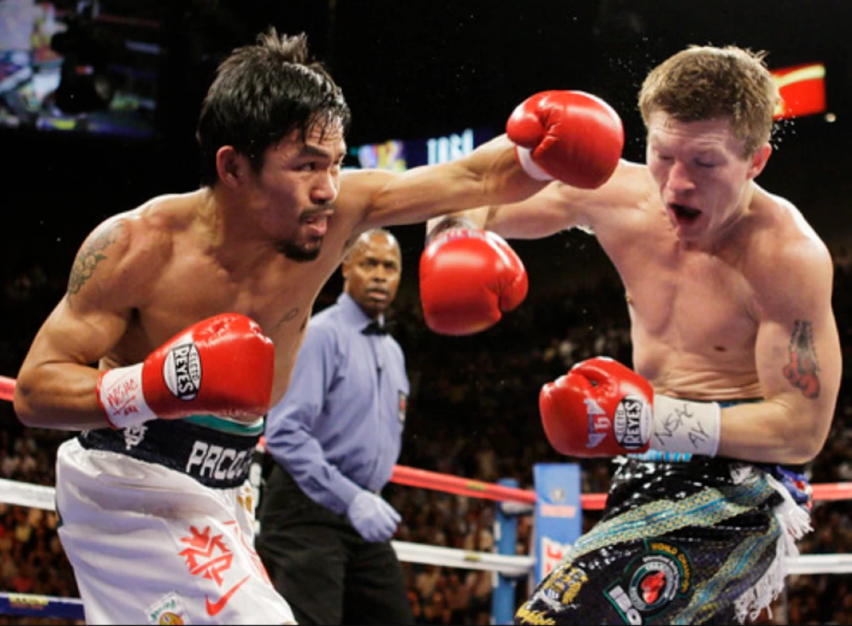 Manny Pacquiao, left, and Ricky Hatton slug it out in 2009. (File Photo/AP)