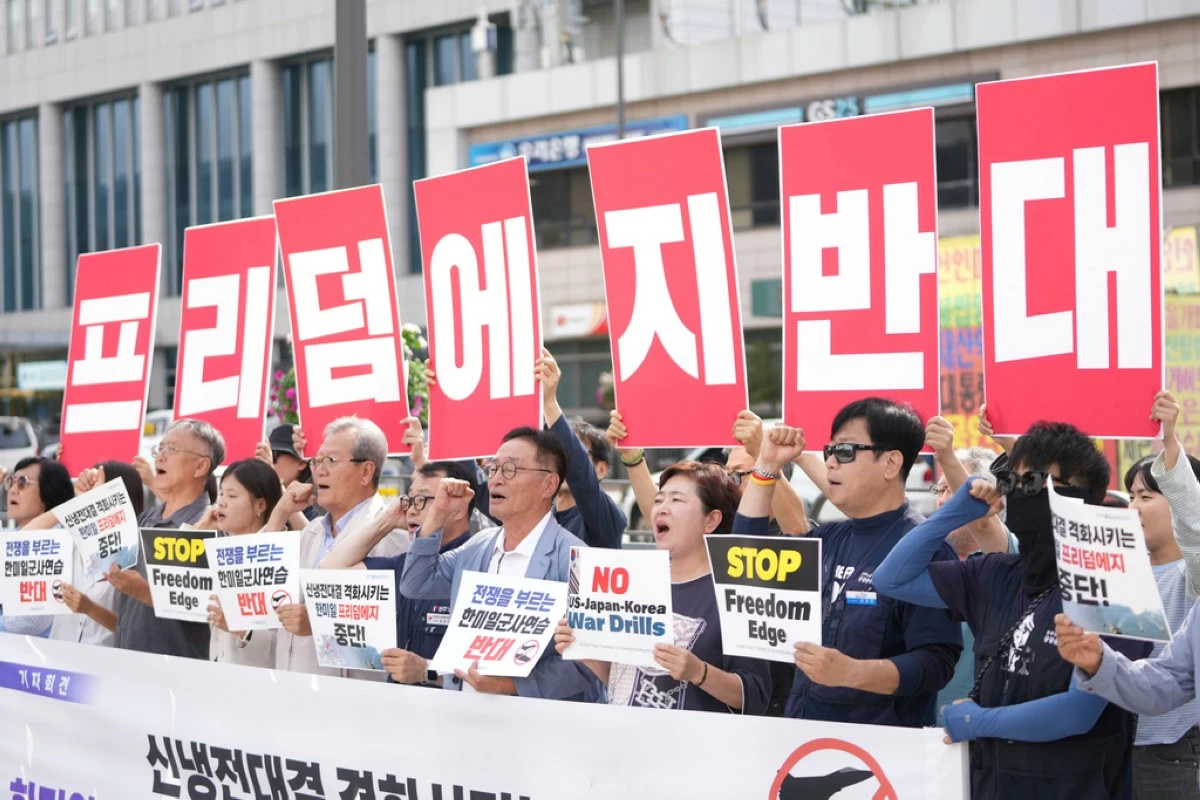 Protesters shout slogans during a press conference to oppose the military exercise called Freedom Edge in Seoul, South Korea, Monday, Sept. 15, 2025. A banner reads 
