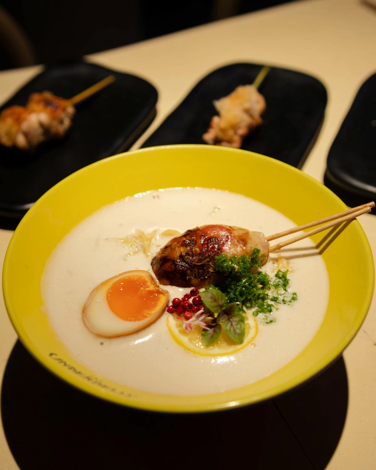 CITRUS COMFORT A bowl of Yuzu Tori Paitan with Ami Tsukune, rich native chicken broth brightened with yuzu and paired with a silky chicken meatball.