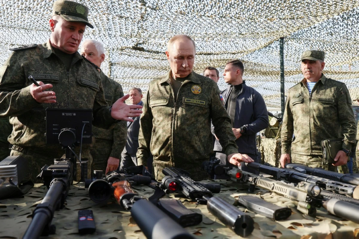 Russian President Vladimir Putin, centre, accompanied by Commander-in-Chief of the Russian Ground Forces Andrey Mordvichev, left, inspects Russian weapons and equipment during his visit to the Russian-Belarusian joint military drills "Zapad 2025" (West 2025) at the Mulino training ground in Nizhny Novgorod region, Russia, Tuesday, Sept. 16, 2025. (Mikhail Metzel/Sputnik, Kremlin Pool Photo via AP)