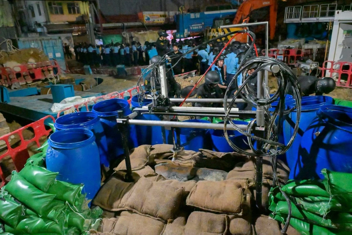 In this photo taken in the early hours of Sept. 20. 2025 and released by Hong Kong Police, police officers prepare to defuse a large U.S.-made bomb left over from World War II that was discovered at a construction site in Hong Kong. (Hong Kong Police via AP)