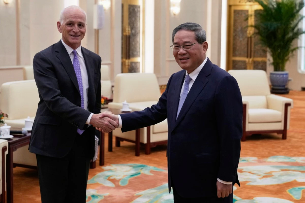 Rep. Adam Smith, D-Wash, left, shakes hands with Chinese Premier Li Qiang as he leads a bipartisan group of U.S. lawmakers for a meeting at the Great Hall of the People in Beijing, China, Sunday, Sept. 21, 2025. (AP Photo/Mahesh Kumar A., Pool)