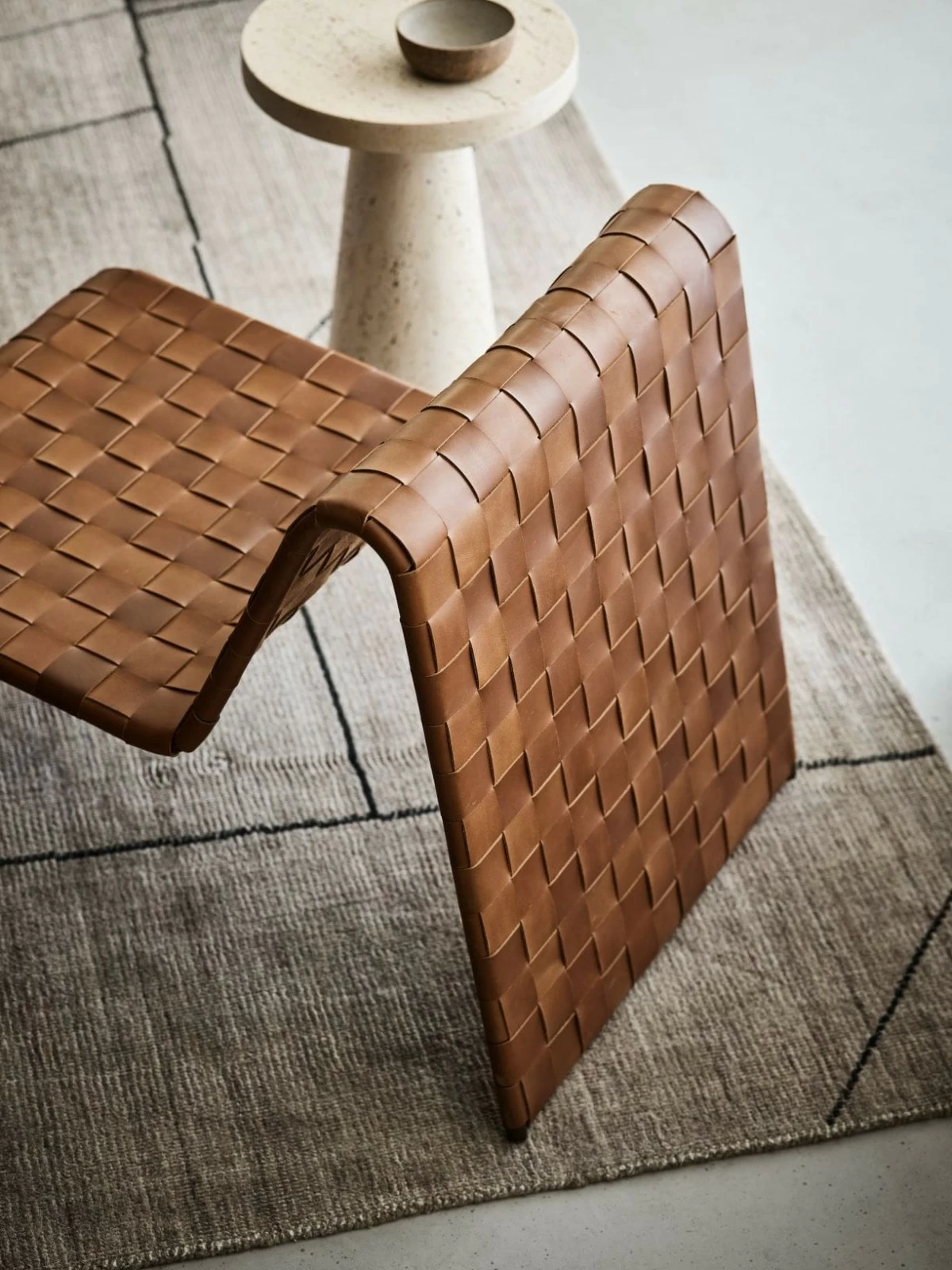 The Saddle accent chair is the perfect blend of nostalgia and modern design. Exuding a cool 1970s vibe with its lived-in warm cognac leather, the chair is inspired by emerging fashion trends with woven textures seen in high-end accessories. A Crate & Barrel exclusive.
