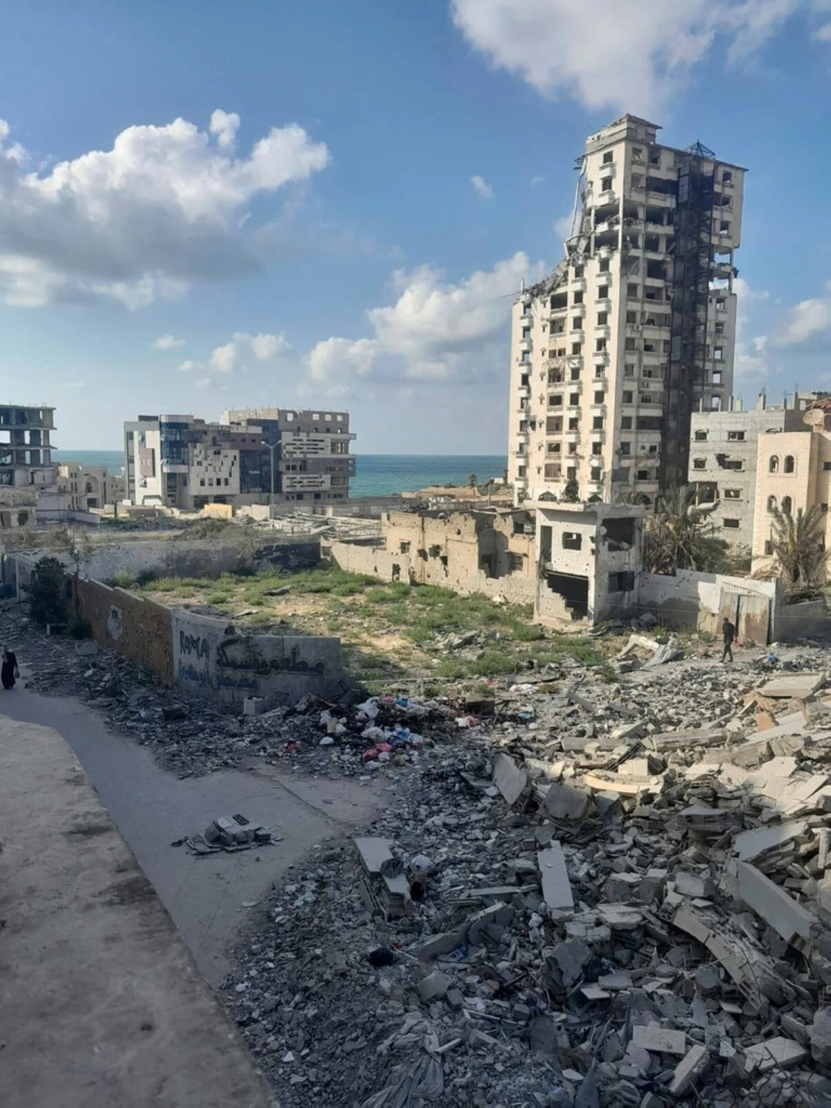 A photo taken by Noor Abu Hassira, an injured mother stranded in Gaza City as Israeli troops approach, show the destruction outside her parent's home, where she is sheltering with her three daughters in the Gaza Strip, Sunday, Sept. 21, 2025 (Noor Abu Hassira via AP)