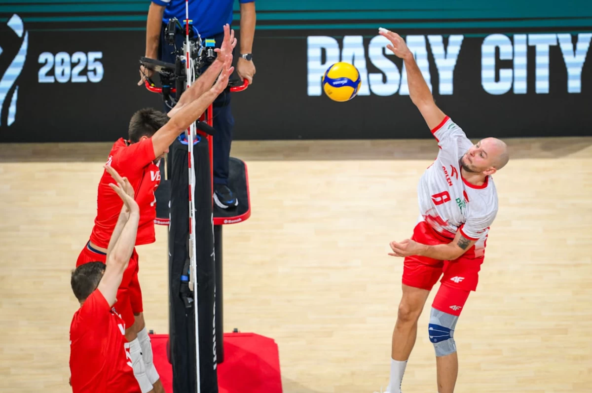 Bartosz Kurek, right, scores for Poland. (Volleyball World)