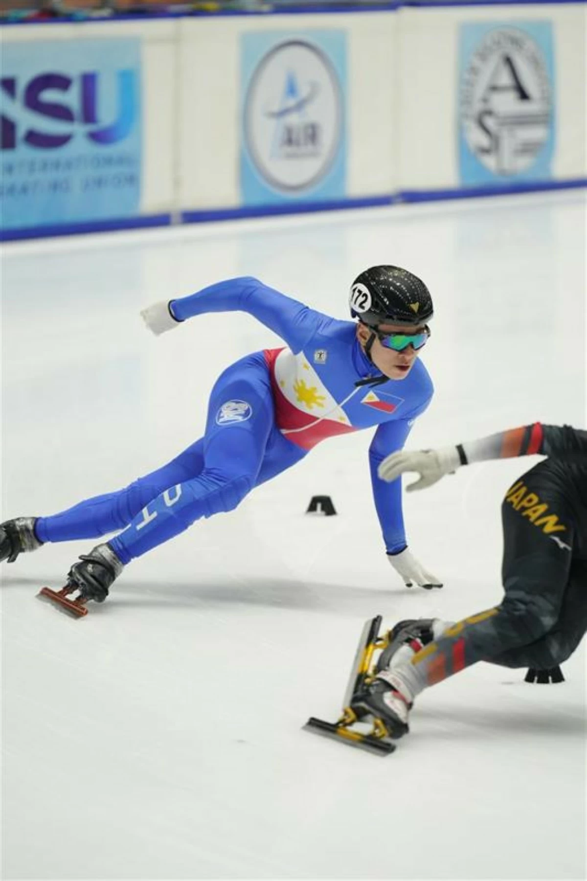 Hans Matthew Buemio, the first homegrown Filipino skater to qualify for and compete in the ISU Junior World Cup Series in short track speed skating, in action on the ice.
