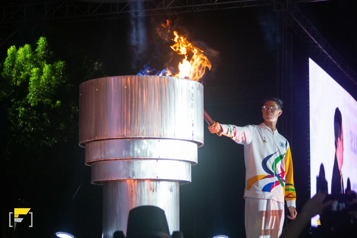 Olympian EJ Obiena lights the torch during the UAAP Season 88 Opening Ceremonies