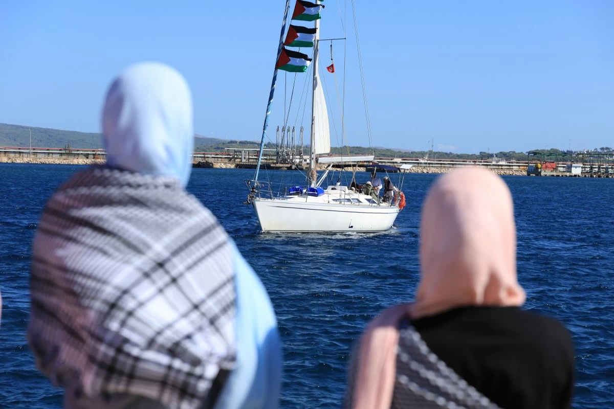 Supporters watch as a boat that is part of the Global Sumud Flotilla departs to Gaza to deliver aid amidst Israel's blockade on the Palestinian territory, in the Tunisian port of Bizerte, Saturday, Sept. 13, 2025. (AP Photo/Anis Mili)