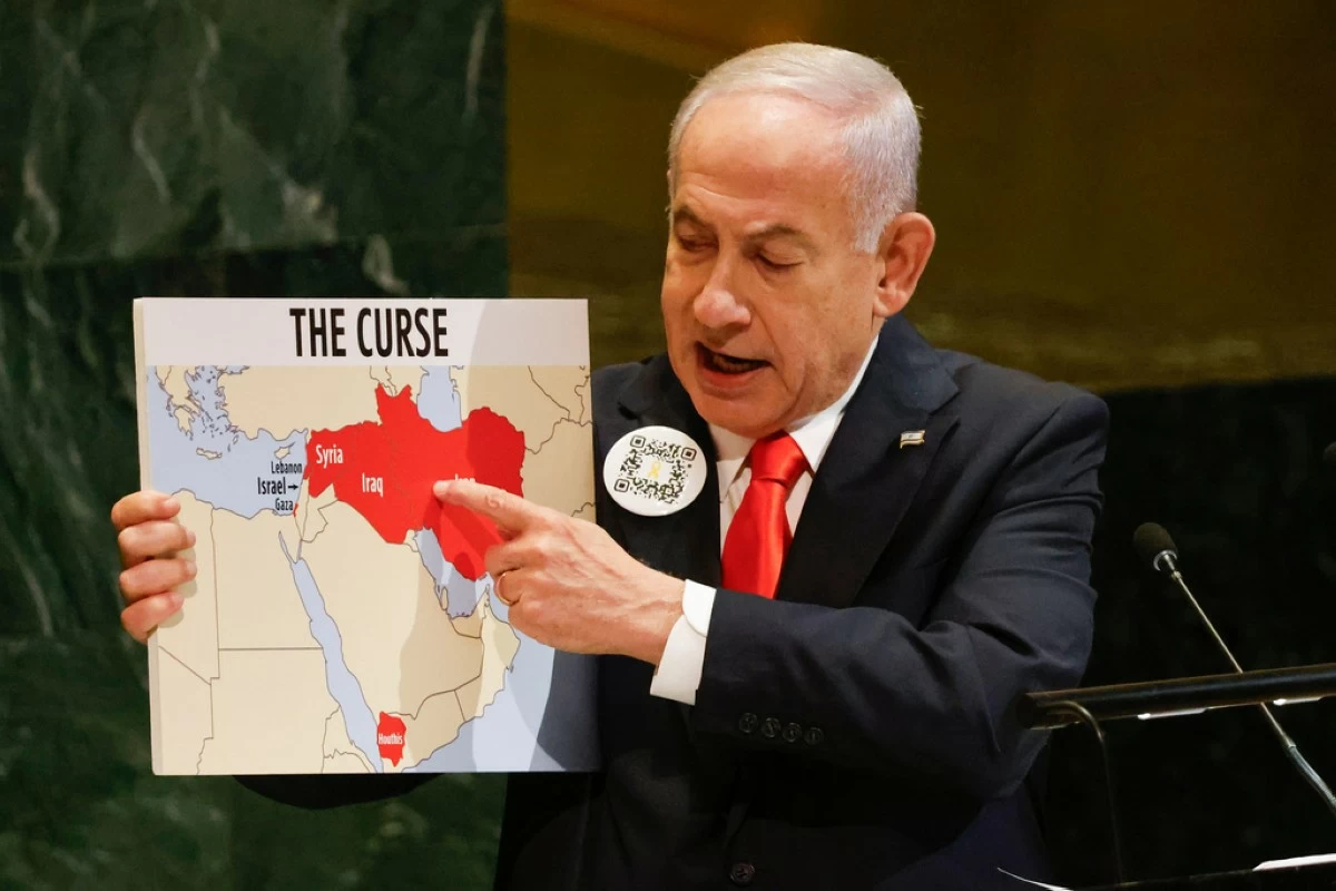 Israeli Prime Minister Benjamin Netanyahu holds up a map while speaking at the 80th session of the United Nations General Assembly, Friday, Sept. 26, 2025, at U.N. headquarters. (AP Photo/Stefan Jeremiah)