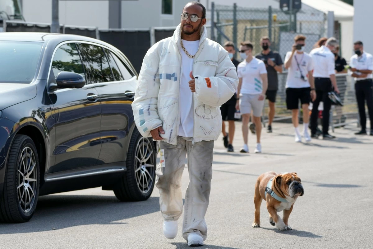 FILE - Mercedes driver Lewis Hamilton of Britain and his dog Roscoe arrive at the Monza racetrack, in Monza, Italy, Thursday, Sept. 9, 2021. (AP Photo/Luca Bruno, File)