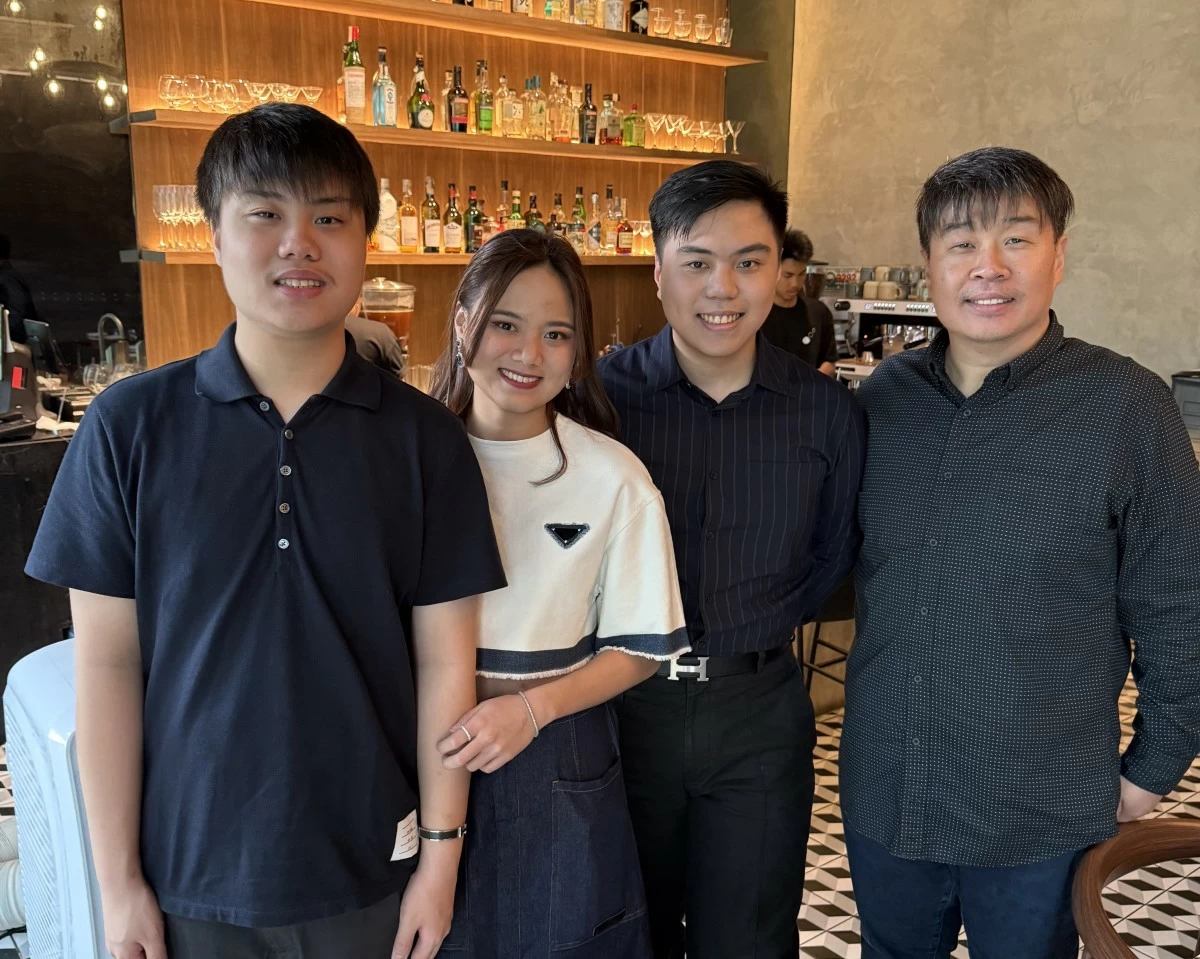 Franklin (far right) with his three children who manage Three Dots