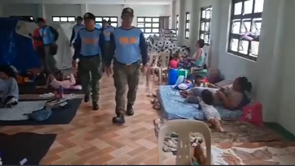 Policemen check the condition of local residents who were evacuated from their homes in Oriental Mindoro as part of the safety measures during the onslaught of typhoon "Opong". (photo: PNP) 