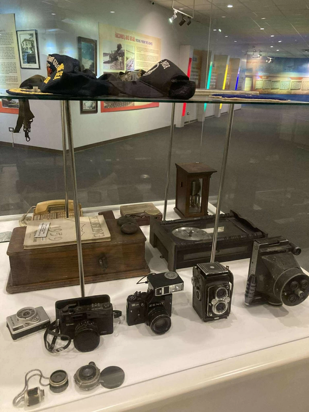 OLDEN DAYS Antique cameras and veteran hats on display at the Clark Museum.