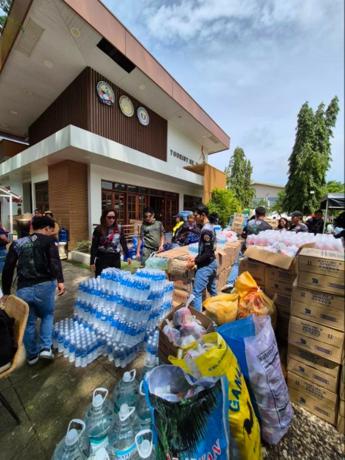 Volunteers sort food, water, and other supplies for families in quake-hit communities. (Photo courtesy of the Local Government of Medellin, Cebu)