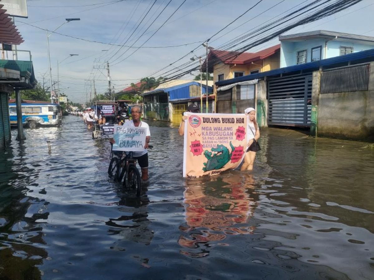 Without fear, over two thousand people waded through knee-deep floodwaters to participate in a prayer rally carrying the 

theme "Be Honest Tapat Dapat" to be held in front of the new municipal hall of Balagtas, Bulacan on Saturday, Oct. 4, 2025. (Freddie Velez)