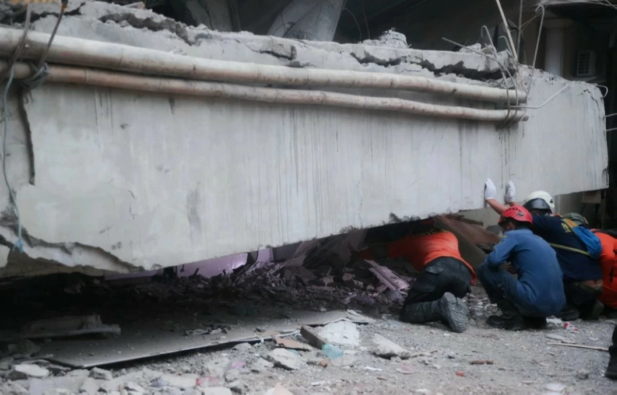 Indonesian rescuers search for missing students after school collapse kills 37