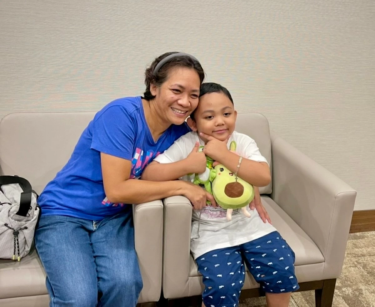 Roda Shane Magat and her son Ieauan pose for a photo before his last proton therapy session. (JEL SANTOS)