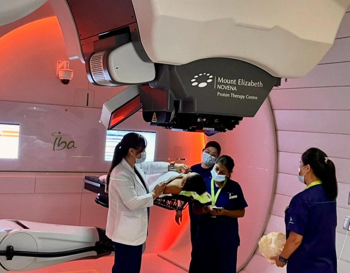 Medical staff of Mount Elizabeth Novena Hospital in Singapore prepare Ieauan Magat for his final proton therapy session. (JEL SANTOS)