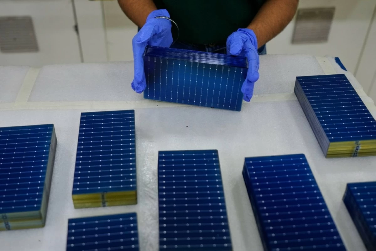 FILE - A worker stacks solar cells in a ReNew manufacturing plant on the outskirts of Jaipur, India, Thursday, Aug. 21, 2025. (AP Photo/Manish Swarup, File)