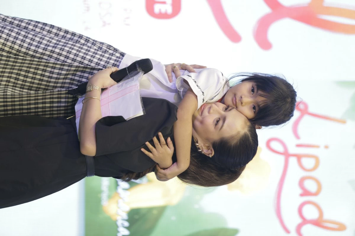 A heartfelt moment: Mika Salamanca shares a warm hug with one of the kids at Book Nook, showing how reading and storytelling create genuine connections.