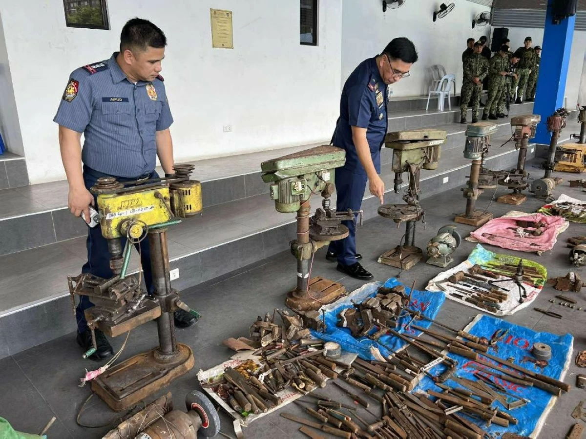 POLICE Brig. Gen. Redrico Maranan (right), chief of the Police Regional Office-Central Visayas, inspects assorted firearms and gun-making paraphernalia seized in various operations in Danao City, Cebu province. (Contributed photo)