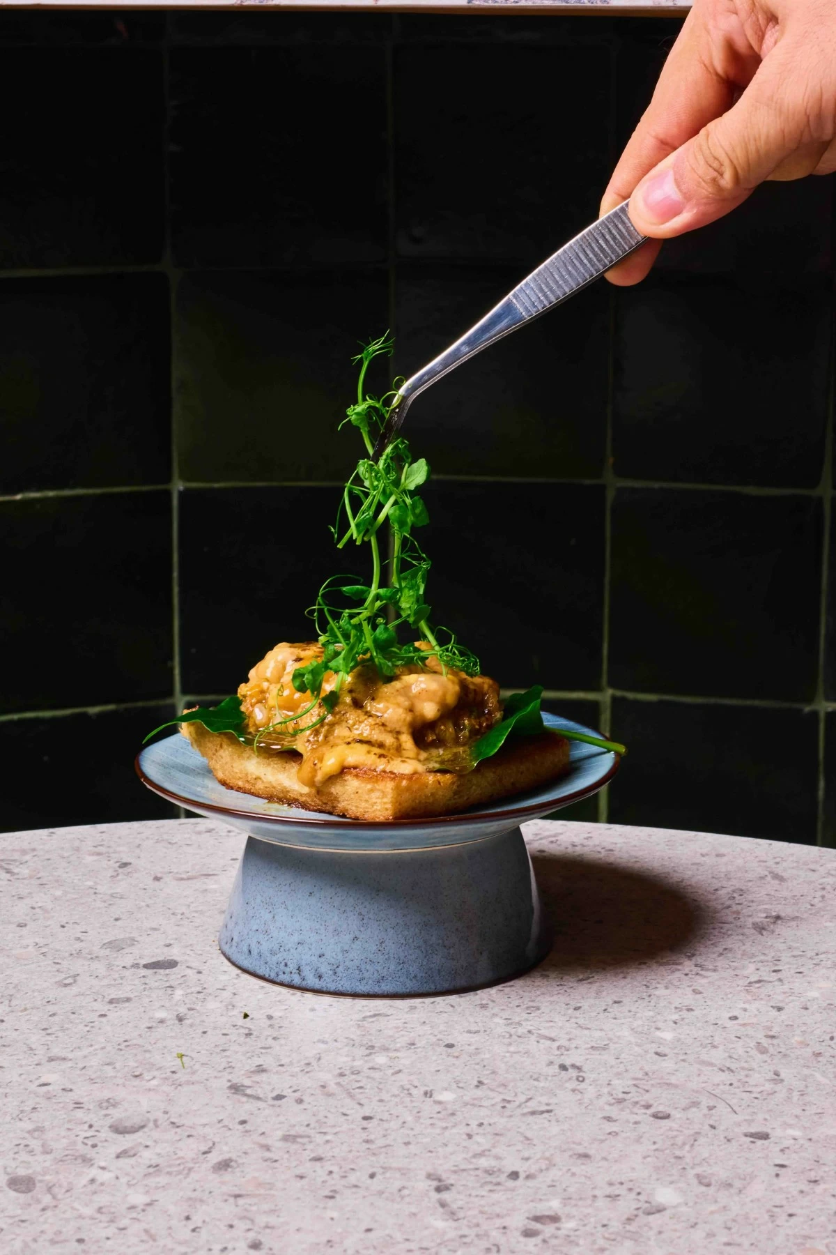 OCEAN LUXE Uni toast layers creamy sea urchin on crisp bread, offering a bite that is both indulgent and restrained.