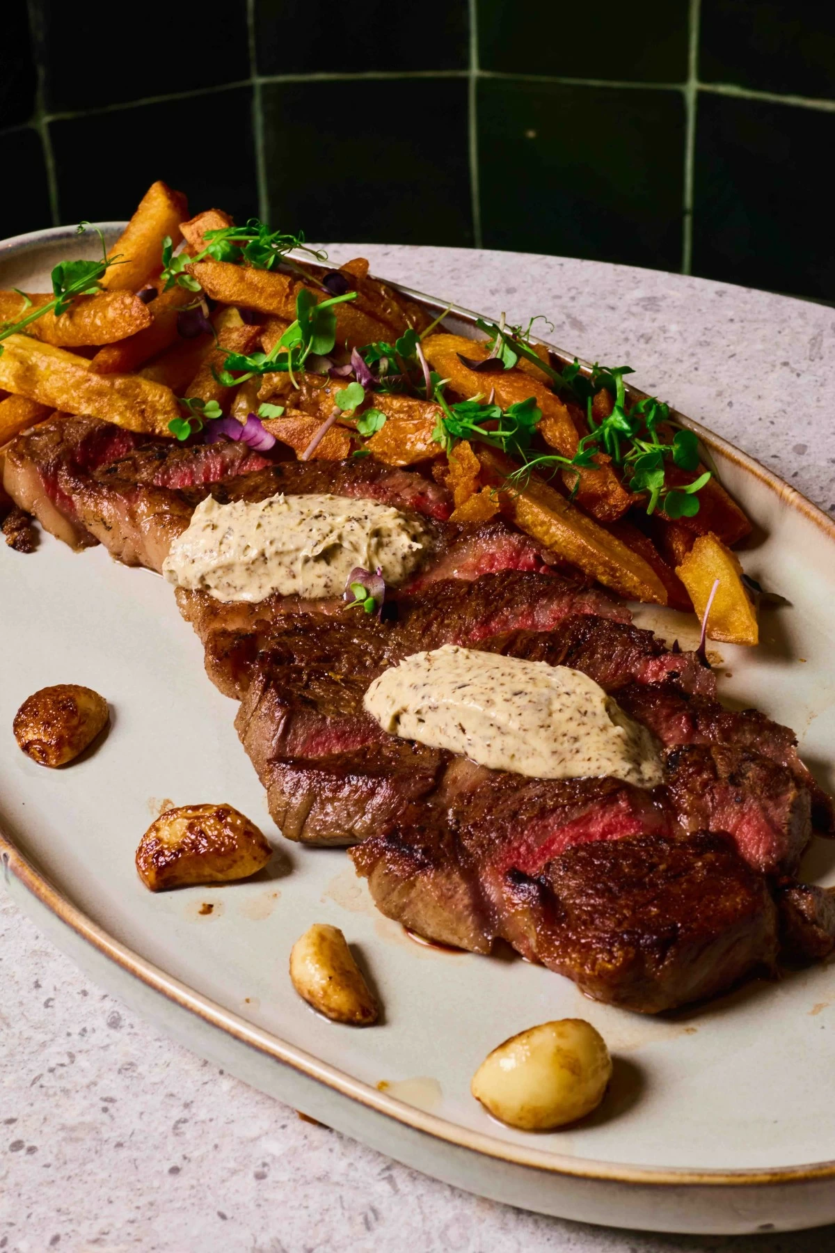 INDULGENT CUT Mita’s signature steak is topped with bone marrow foie gras butter, a rich centerpiece that embodies the restaurant’s balance of refinement and comfort.