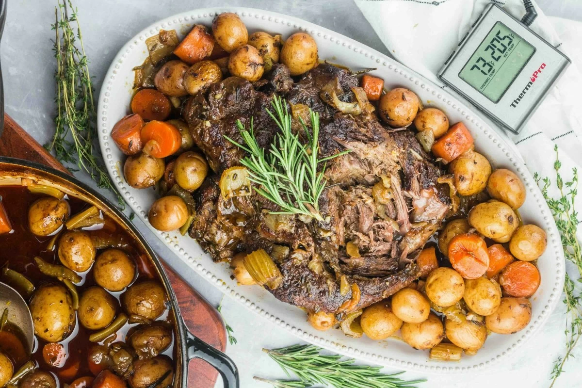 FAMILY FEAST A hearty beef pot roast takes center stage on a large serving platter, surrounded by vegetables and rich gravy, proving that comfort food can be both festive and budget friendly. (Photo from Unsplash)