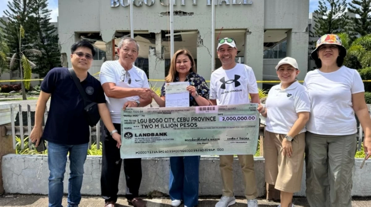 The Muntinlupa City government's Trina Biazon turns over the P2 million financial assistance check to the Bogo City government in Cebu (Photo from the Muntinlupa City government)  