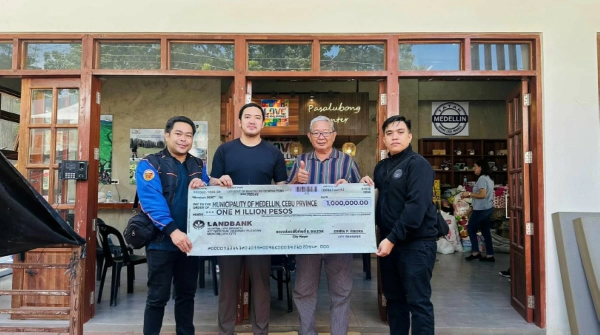 Muntinlupa officials turn over the P1 million financial assistance check to the Medellin municipal government in Cebu (Photo from the Muntinlupa City government)  