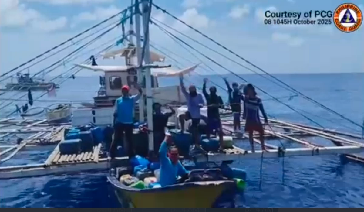 A group of Filipino fishermen express gratitude to PCG and BFAR personnel for the assistance they receive during the relief distribution activity near Bajo de Masinloc and Escoda Shoal on Wednesday, Oct. 8, 2025. (photo PCG) 
