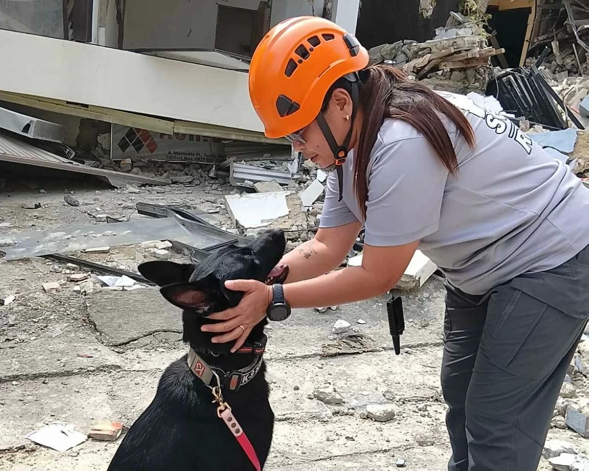 Metro Manila Dog Association K9, Ghost, with handler Sheryl Impacis on site during the relief operations in Bogo City.