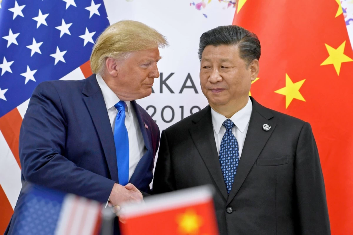 FILE - U.S. President Donald Trump, left, shakes hands with Chinese President Xi Jinping during a meeting on the sidelines of the G-20 summit in Osaka, western Japan,  June 29, 2019. (AP Photo/Susan Walsh, File)