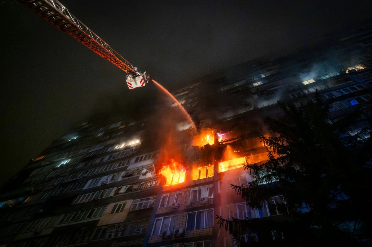 Emergency services personnel work to extinguish a fire following a Russian attack in Kyiv, Ukraine, Friday, Oct. 10, 2025. (AP Photo/Dan Bashakov)