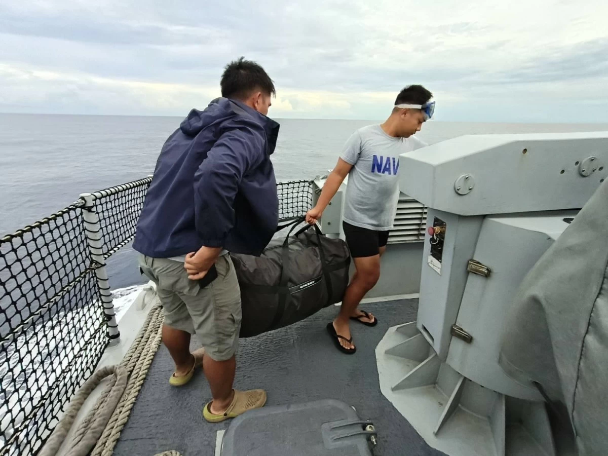 Philippine Navy personnel retrieve a black bag containing 16 kilos of suspected high-grade marijuana with an estimated worth of P19.2 million. The floating drugs were recovered in the vicinity of Escoda Shoal in the West Philippine Sea on Oct. 18, 2025. (Photo: Western Naval Command)