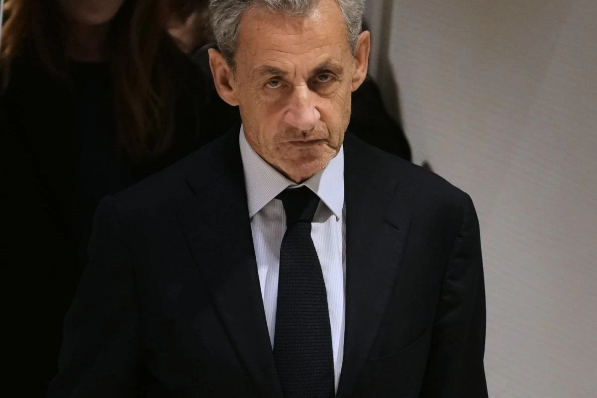 FILE- Former French President Nicolas Sarkozy leaves after a Paris court sentenced him to 5 years after finding him guilty of criminal conspiracy in an alleged scheme to finance his 2007 campaign with funds from Libya, Thursday, Sept. 25, 2025 in Paris. (AP Photo/Christophe Ena, File)